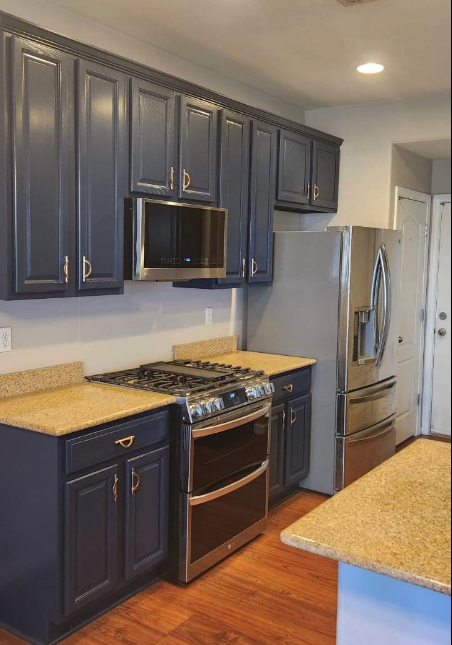 Refinished kitchen cabinets in deep navy blue