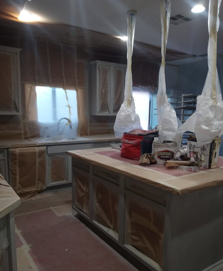 Kitchen masked off with plastic sheeting, prepped for interior painting